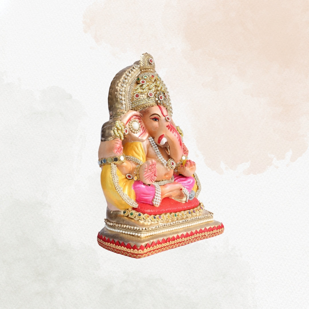 11 Inch – Elegant Seated Ganesha Idol in Pink & Yellow Attire | Shadu Mitti Eco-Friendly Clay Murti with Golden Beaded Crown & Pearl Accents