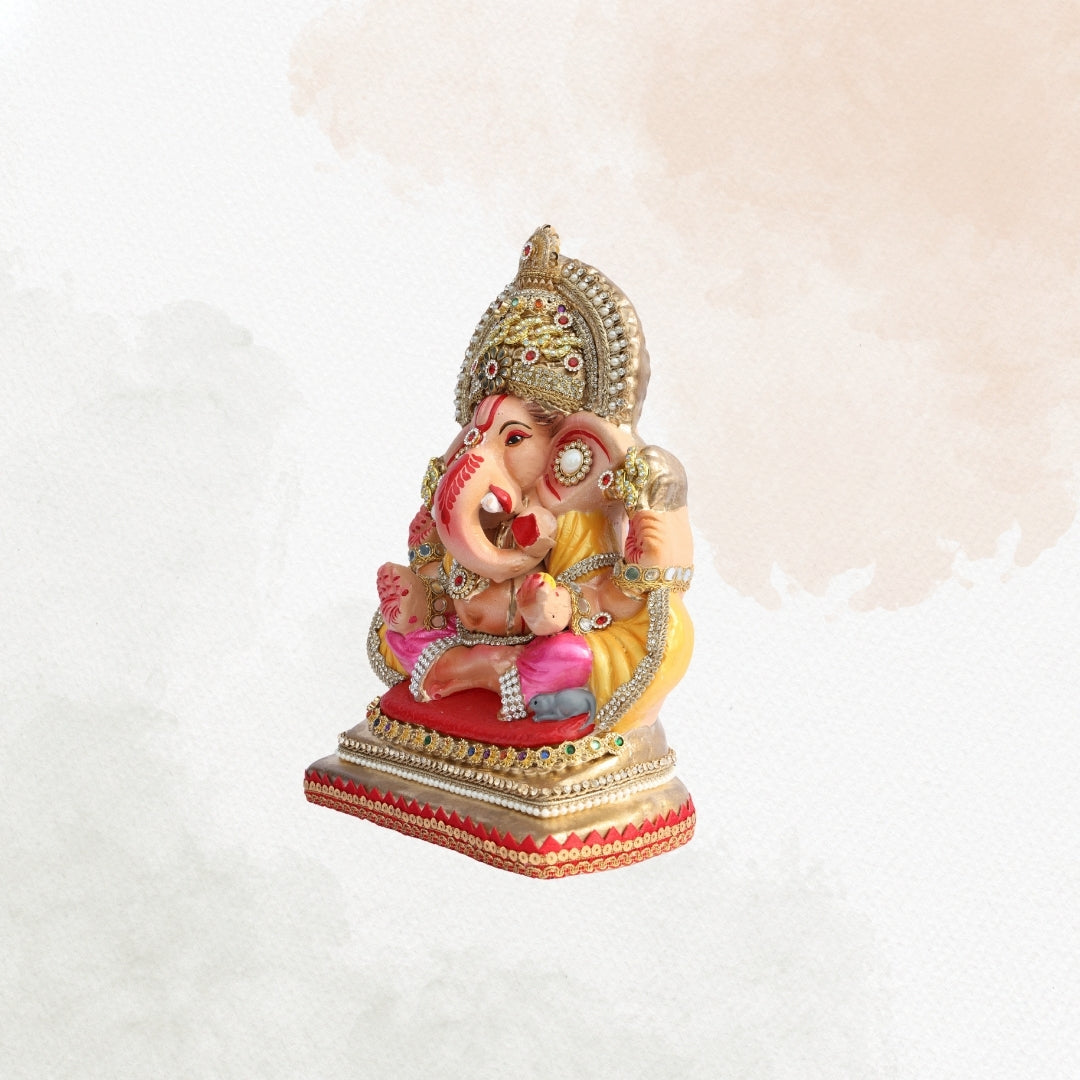 11 Inch – Elegant Seated Ganesha Idol in Pink & Yellow Attire | Shadu Mitti Eco-Friendly Clay Murti with Golden Beaded Crown & Pearl Accents