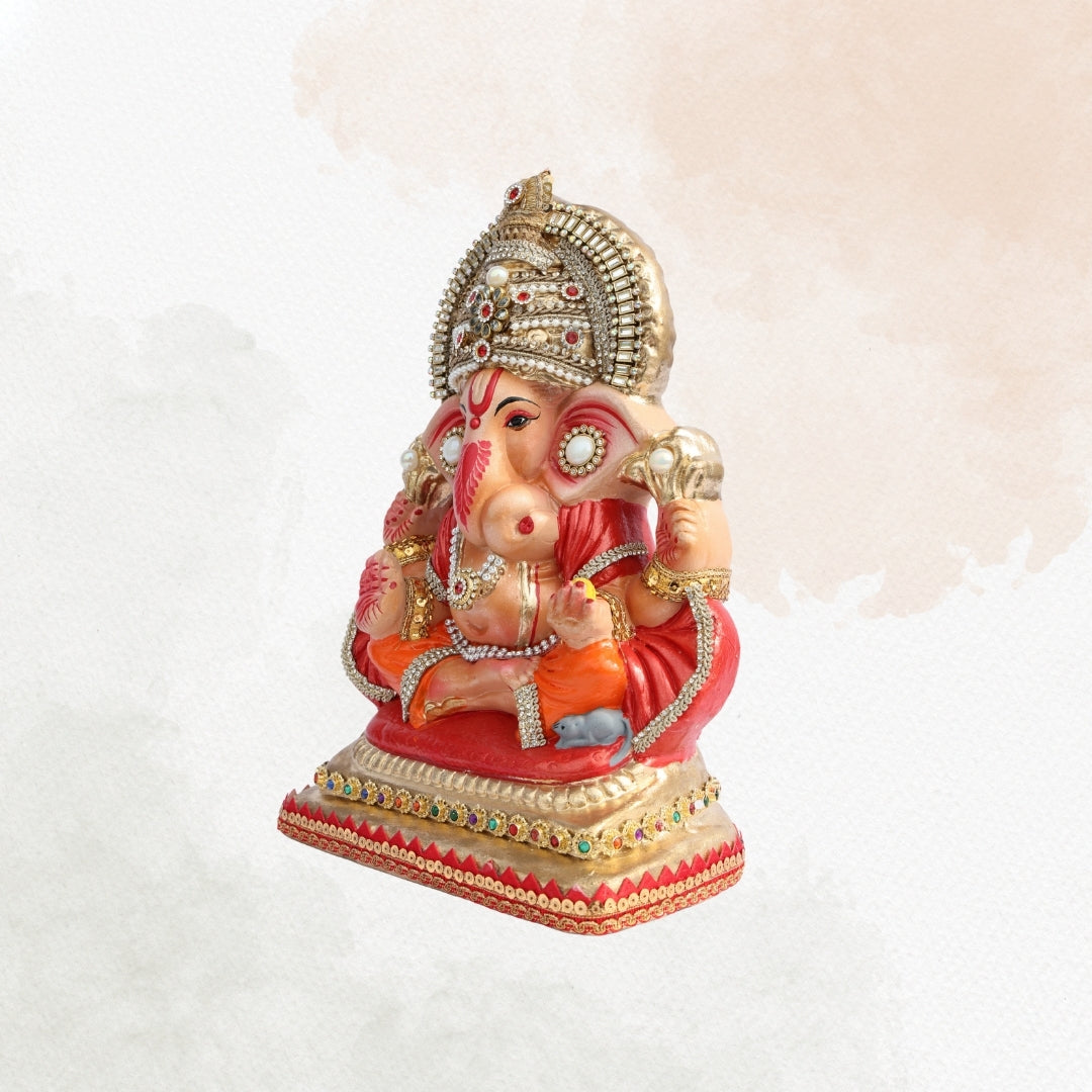 11 Inch – Royal Seated Ganesha Idol in Orange Attire | Shadu Mitti Clay Murti with Beaded Crown & Pearl Stone Work