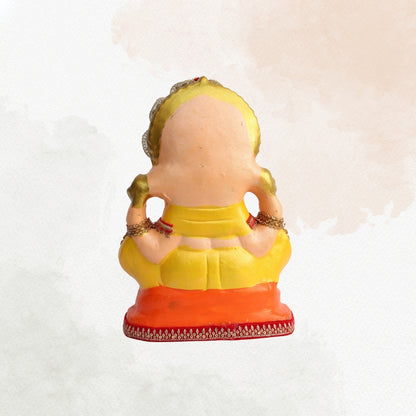 11 Inch – Divine Seated Ganesha Idol in Yellow Attire | Shadu Mitti Clay Murti with Silver Crown & Multistone Work