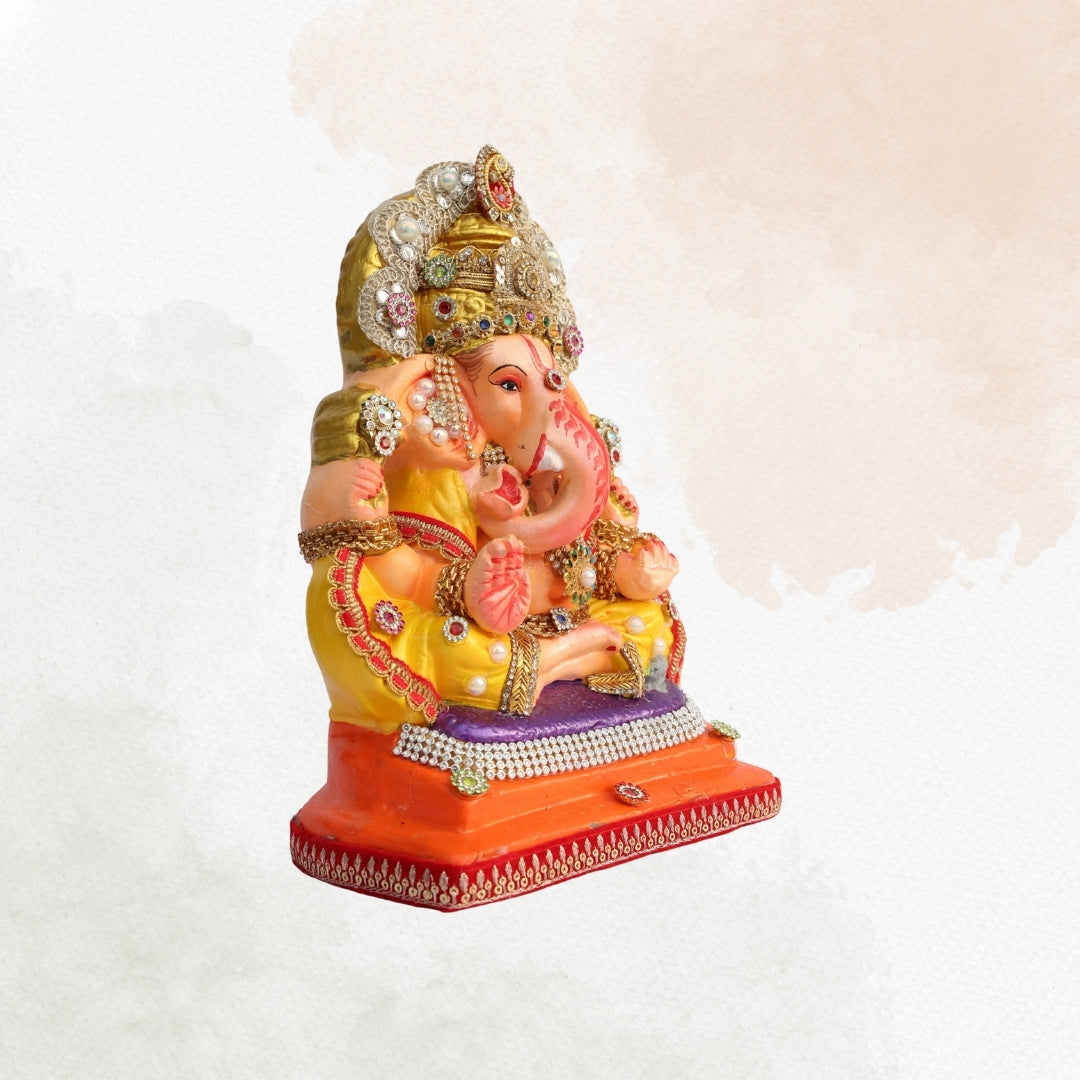 11 Inch – Divine Seated Ganesha Idol in Yellow Attire | Shadu Mitti Clay Murti with Silver Crown & Multistone Work