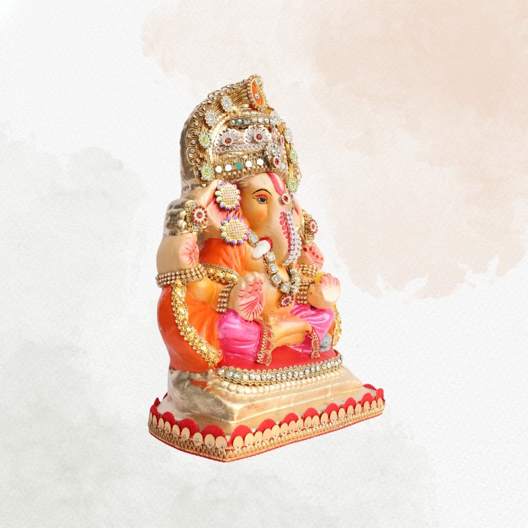 11 Inch – Ganesha Idol in Pink-Orange Attire with Grand Golden Crown | Eco-Friendly Shadu Mitti Ganpati Murti with Sparkling Detailing & Classic Seated Pose