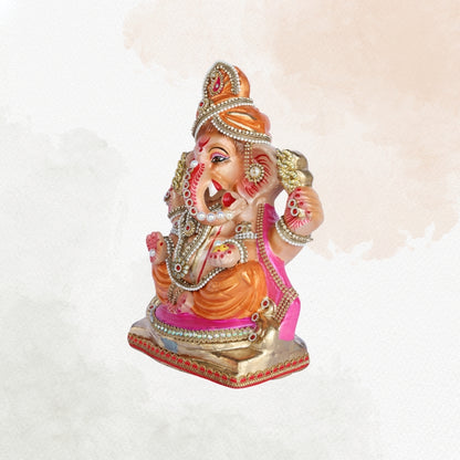 13 Inch – Regal Seated Ganesha Idol in Orange-Pink Attire Shadu Mitti Clay Murti with Gold Crown & Stone Work