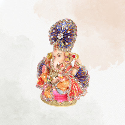 13 Inch – Ganesha Idol with Royal Blue Crown, Orange Attire & Decorative Fan-Style Pagdi